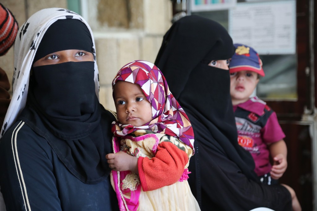 Yemeni women hold their children in the capital Sanaa, during a visit by Ertharin Cousin, Executive Director of the World Food Programme, Aug. 18, 2015. The United Nations says the war in Yemen has pushed the country to the brink of famine, with both commercial food imports and aid deliveries held up by the fighting and millions of hungry women and children facing possible starvation. (WFP/Abeer Etefa via AP)