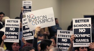 A group of people protest against Boston holding the Olympic games in 2024. Los Angeles may step in to take the bid. (AP photo)