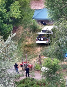 In this aerial photo, investigators look for evidence in the field where the body of a 12-year-old girl found on Friday , July 17, 2015, in West Valley City, Utah. (Tom Smart/The Deseret News via AP) SALT LAKE TRIBUNE OUT; MAGS OUT; MANDATORY CREDIT