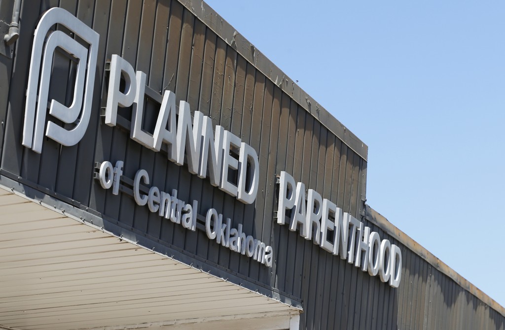 A sign at a Planned Parenthood Clinic is pictured in Oklahoma City, Friday, July 24, 2015. U.S. Sen. James Lankford, R-Okla., a Baptist minister and fierce abortion opponent, has introduced a bill in the U.S. Senate that would end all federal funding for Planned Parenthood unless the organization stops performing abortions. Recently released videos that show a Planned Parenthood official discussing the distribution of fetal body parts are being used by anti-abortion advocates in Oklahoma to seek political contributions and bolster support for legislation to further restrict abortion. (AP Photo/Sue Ogrocki)