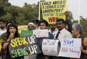Activists from Pakistan's Child Rights Movement, rally to condemn a child abuse scandal, Monday, Aug. 10, 2015 in Islamabad, Pakistan. Police in eastern Pakistan arrested several men accused of sexually abusing children and distributing videos of the abuse, authorities said Sunday. More arrests were expected. Poster in Urdu reads: 'Stop Child Abuse'. (AP Photo/B.K. Bangash)