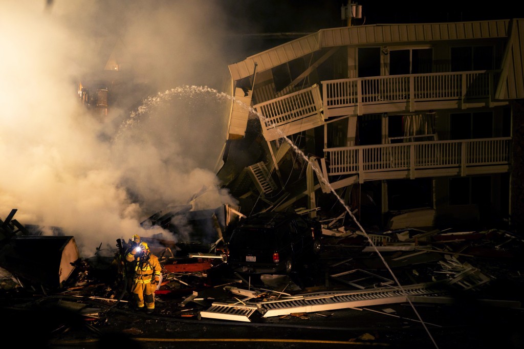 Officials work at the scene of an explosion at a Motel 6 in Bremerton, Wash., on Aug. 18, 2015. An explosion demolished part of the motel critically injuring a gas company worker just minutes after the acting hotel manager had evacuated the building because she could smell and hear a gas leak. (Erika Schultz/The Seattle Times via AP) 