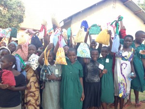 Ugandan girls proudly holding up their personal hygiene kits provided by the group Smith worked with.