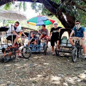 Members of the Hey Joe Show sit on Trisikads in the Philippines during their summer tour. "Public transportation at its finest," joked Mingus. (Hey Joe Show)