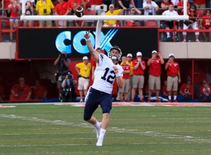 BYU quarterback Tanner Mangum throws a 42-yard Hail Mary with no time left, which was caught for the game-winning touchdown by wide receiver Mitch Mathews, unseen, giving BYU a 33-28 victory over Nebraska in an NCAA college football game in Lincoln, Neb., Saturday, Sept. 5, 2015. (AP Photo/Nati Harnik)
