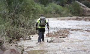 A member of a search and rescue team searches along the Virgin River Wednesday, Sept. 16, 2015, in Zion National Park, near Springdale, Utah. Seven hikers who entered a narrow desert canyon for a day of canyoneering became trapped when a flash flood filled the chasm with water, killing at least five of them in Zion National Park in southern Utah, officials said Wednesday. (AP Photo/Rick Bowmer)