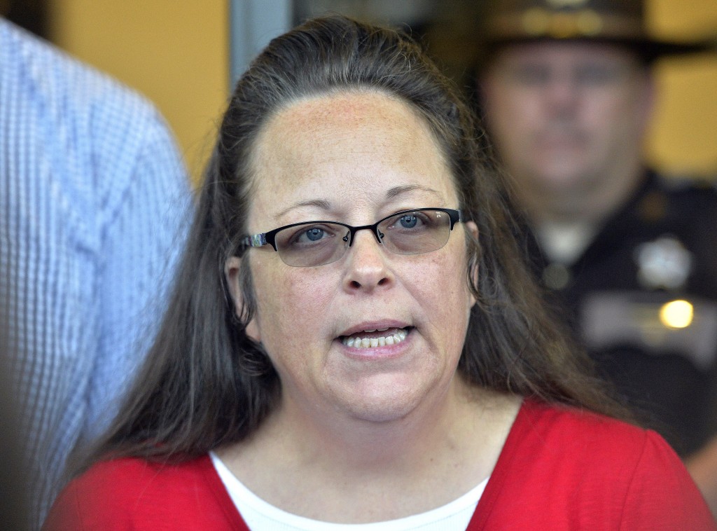 Rowan County Clerk Kim Davis makes a statement to the media at the front door of the Rowan County Judicial Center in Morehead, Ky., Monday, Sept. 14, 2015. Davis announced that her office will issue marriage licenses under order of a federal judge, but they will not have her name or office listed. (AP Photo/Timothy D. Easley)