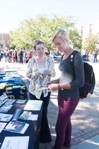 Two students look at a booth at the Involvapalooza event. This semester's event took place on Sept. 18, 2015. (Brigham Young University)
