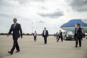 President Barack Obama walks across the tarmac to greet guests after arriving at Selfridge Air National Guard Base, Wednesday, Sept. 9, 2015, in Harrison Township, Mich. Obama will tour Michigan Technical Education Center with Jill Biden and announce new steps to expand apprenticeships and push to make community college free for responsible students. (AP Photo/Andrew Harnik)