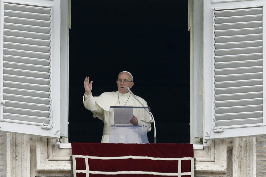 Pope Francis delivers a blessing from his studio's window overlooking St. Peter's Square on the occasion of the Angelus noon prayer at the Vatican, Sunday, Sept. 13, 2015. (AP Photo/Gregorio Borgia)