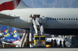 Firefighters enter a plane that caught fire at McCarren International Airport Tuesday, Sept. 8, 2015, in Las Vegas. (Associated Press)