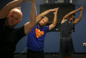 In this Sept. 30, 2015, photo, participants in Wade Knight's "Broga" class, a yoga class for men, perform yoga poses during the class at the Summit Athletic Club in St. George, Utah. (Jud Burkett/The Spectrum via AP) NO SALES; MANDATORY CREDIT