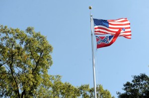 In a October 16, 2015 photo, the Mississippi state flag and U.S. flag fly in the Circle on campus at the University of Mississippi in Oxford, Miss. The state flag was removed Monday, Oct, 26, 2015, days after the student senate, the faculty senate and other groups adopted a student-led resolution calling for removal of the banner from campus. (Bruce Newman/Oxford Eagle via AP)