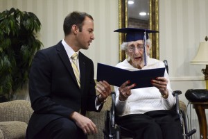 Catholic Central High School Principal Greg Deja, left, presents 97-year-old Margaret Thome Bekema with her honorary diploma at Stonebridge Manor on Thursday, Oct. 29, 2015 in Grand Rapids, Mich.. Bekema began her education at Catholic Central in 1932 but sacrificed completing her degree at that time to take care of her mother who had cancer and her younger siblings. (Emily Rose Bennett/The Grand Rapids Press via AP) ALL LOCAL TELEVISION OUT; LOCAL TELEVISION INTERNET OUT; MANDATORY CREDIT (Emily Rose Bennett | MLive.com)