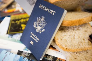 Passports, travel brochures, plane tickets and other travel-related items sit next to gluten-free bread. Many who travel overseas with Celiac disease or a gluten intolerance have extra precautions to take. (Maddi Driggs)