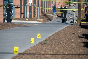 Police officers investigate a shooting at Northern Arizona University campus in Flagstaff, Ariz., Friday, Oct. 9, 2015. An overnight confrontation between two groups of students escalated into gunfire early Friday when a student killed one person and wounded three others, authorities said. (Michael Schennum/The Arizona Republic via AP) MARICOPA COUNTY OUT; MAGS OUT; NO SALES; MANDATORY CREDIT