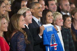 President Barack Obama holds a jersey and poses for photographs during a ceremony to honor the 2015 FIFA Women's World Cup champion U.S. National Soccer Team, Tuesday, Oct. 27, 2015, in the East Room of the White House in Washington. (AP Photo/Evan Vucci)