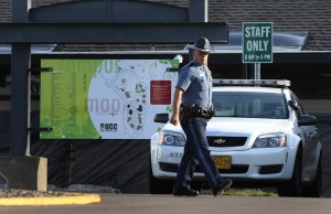 An Oregon State Patrol Trooper walks the grounds of Umpqua Community College near Roseburg, Ore. Tuesday Oct. 6, 2015 in the aftermath of the mass shooting on the Roseburg campus. (Chris Pietsch/The Register-Guard via AP)