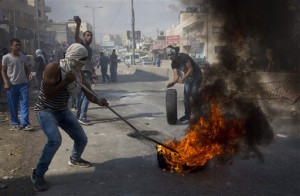 Young Palestinians burn tires in the midst of clashes with Israeli forces in Qalandia, Tuesday, Oct. 6, 2015.   (AP Photo/Majdi Mohammed)