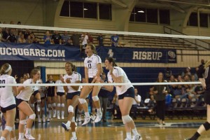 The BYU women's volleyball team celebrates after a rally against ISU. Danelle Parady (center, jumping) was a vital player on the court prior to injuring her pinky this season. (The Universe)