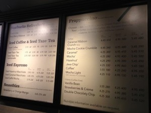 A menu board showing calorie counts hangs at a Starbucks in New York. Tracking calories at chain restaurants is supposed to become easier next year, but new studies raise questions about whether the counts actually make a difference for diners and eateries. (Associated Press)