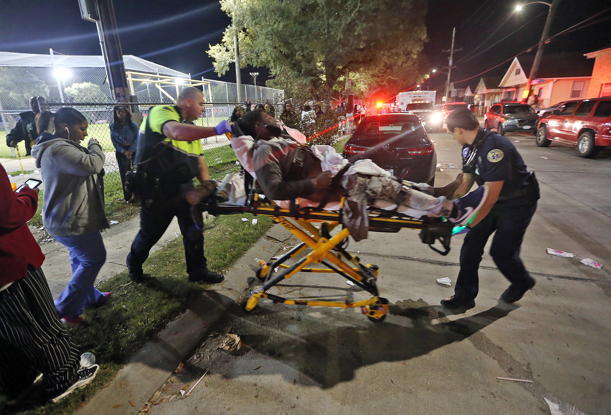 Officials remove a man from the scene following a shooting in New Orleans' 9th Ward on Sunday, Nov. 22, 2015. Police spokesman Tyler Gamble says police were on their way to break up a big crowd when gunfire erupted at Bunny Friend Park. (Michael DeMocker/NOLA.com The Times-Picayune via AP) MAGS OUT; NO SALES; USA TODAY OUT; THE BATON ROUGE ADVOCATE OUT; THE NEW ORLEANS ADVOCATE OUT; MANDATORY CREDIT