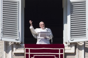 Pope Francis delivers his blessing during the Angelus noon prayer he celebrated from the window of his studio overlooking St. Peter's Square, at the Vatican, Sunday, Nov. 1, 2015. (AP Photo/Andrew Medichini)