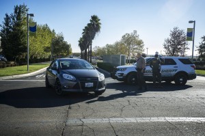 Merced County Sheriff deputies direct traffic out of the University of California, Merced, as the campus is placed on lockdown after a stabbing in Merced, Calif., Wednesday, Nov. 4, 2015. An assailant stabbed five people as students headed to class at the rural university campus in central California before police shot and killed him, authorities said. (Andrew Kuhn/Merced Sun-Star via AP)
