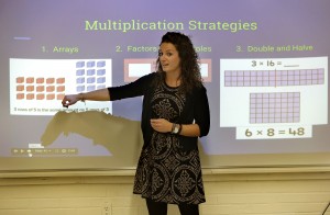In this Monday, Oct. 19, 2015 photo fourth grade math teacher Felicia Connelly, of South Kingstown, R.I., teaches Common Core math techniques during a workshop at a community center in Westerly, R.I. The Westerly school district is running the workshop for parents to teach them Common Core math so they can help their grade schoolers with their homework. (AP Photo/Steven Senne)