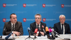 Lower Saxony's state Interior Minister Boris Pistorius, German Federal Interior Minister Thomas de Maiziere and Reinhardt Rauball, acting head of the German soccer federation attend a press conference in Hannover, northern Germany, Tuesday, Nov. 17, 2015 after the international soccer friendly between Germany and the Netherlands was cancelled due to the fear of an extremist attack. (Ole Spata/dpa via AP)