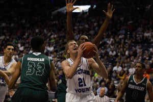 Junior-transfer Kyle Davis comes down with a rebound against UVU. Davis had 17 points and 20 rebounds. (Maddi Driggs)