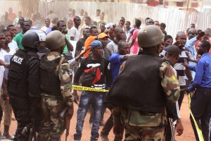 Mali troops try to control a crowd of onlookers near the Radisson Blu hotel, after an attack by gunmen on the hotel in Bamako, Mali, Friday, Nov. 20, 2015. Islamic extremists armed with guns and grenades stormed the luxury Radisson Blu hotel in Mali's capital Friday morning, and security forces worked to free guests floor by floor. (Associated Press)