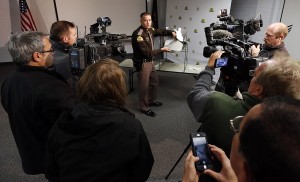 Lt. Paul Kotter of the Utah Highway Patrol shows his protective vest with bullet holes during a press conference in Taylorsville, Utah, Monday, Nov. 30, 2015. Kotter survived despite being shot three times during a shootout after a traffic stop near Hill Air Force Base is returning to work three months after the incident. (Ravell Call/The Deseret News via AP) SALT LAKE TRIBUNE OUT; MAGS OUT; MANDATORY CREDIT; TV OUT