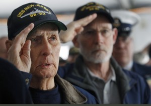 World War II veteran and original crew member of the battleship New Jersey, Russell Collins, left, salutes with others on the battleship during a commemoration of the 74th anniversary of the attack on Pearl Harbor, Monday, Dec. 7, 2015, in Camden, N.J. In Pearl Harbor, the U.S. Navy and National Park Service hosted a ceremony in remembrance of those killed on Dec. 7, 1941. (AP Photo/Mel Evans)
