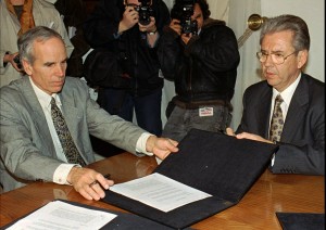 FILE - In this July 7, 1997, file photo, American millionaire Douglas Tompkins, left, and Juan Villarzu, chief of staff of the Chilean president, hold the text of an accord signed in Santiago, Chile. Officials in Chile said Tuesday, Dec. 8, 2015, that the wealthy U.S. businessman and environmental activist has died from severe hypothermia in a kayaking accident. (AP Photo/Santiago Llanquin, File)