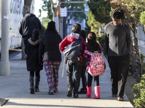 Parents pick up their children from school early, on Tuesday, Dec. 15, 2015, in Los Angeles. The nation's second-largest school district shut down Tuesday after a school board member received an emailed threat that raised fears of another attack like the deadly shooting in nearby San Bernardino. (AP Photo/Ringo H.W. Chiu)