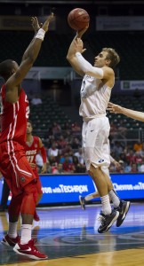 BYU guard Chase Fischer, right, shots over New Mexico guard Sam Logwood, left, in the second half of an NCAA college basketball game at the Diamond Head Classic, Wednesday, Dec. 23, 2015, in Honolulu. (AP Photo/Eugene Tanner)