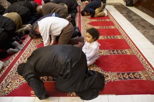 FILE - In this Dec. 4, 2015 file photo, Aiden Abdelaziz, 2, attends prayers with his father, Mohamed Abdelaziz, 22, originally from Cairo, Egypt, at Dar al-Hijrah Mosque in Falls Church, Va. Americans are more likely to say protecting religious liberties of Christians is important than to say the same for Muslims, according to a new poll by The Associated Press and the NORC Center for Public Affairs Research. (AP Photo/Jacquelyn Martin, File)