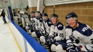 Members of the BYU Hockey team pose on the bench for a photo during a game against the Junior Grizzlies. (Ed Gantt)