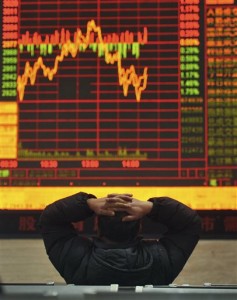 A Chinese stock investor monitors prices at a brokerage house in Fuyang in central China's Anhui province Thursday, Jan. 21, 2016. (AP)