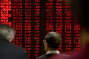 Chinese investors monitor stock prices on an electronic display in a brokerage house in Beijing, Friday, Jan. 29, 2016. Tokyo stocks finished nearly 3 percent higher on Friday while the yen dived as the country's central bank introduced a negative interest rate policy to boost the economy after previous stimulus efforts produced indifferent results. Other Asian markets were higher after China's top economy official said there is no basis for the yuan to continuously weaken. (AP Photo/Mark Schiefelbein)