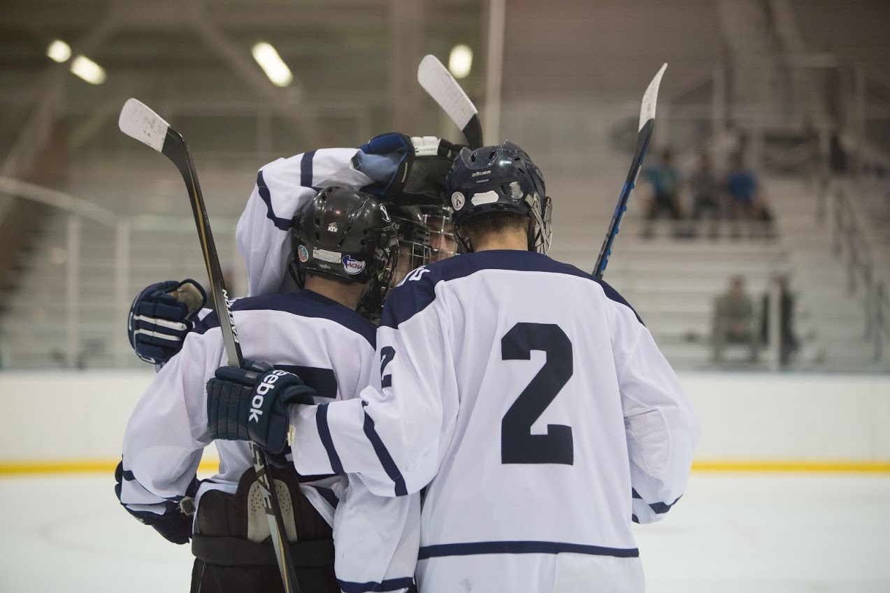 BYU hockey players celebrate during a game. The current BYU hockey squad defeated the alumni team 9-8 on Saturday night. (Universe Archive)