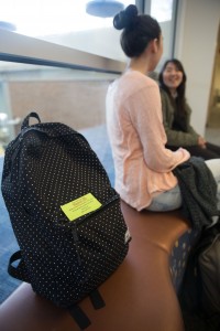 A green note is left by the BYU library security on a unattended backpack. This note warns about the danger of leaving backpacks unattended. 