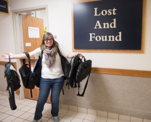 Lost and Found student manager holds backpacks that have been misplaced on campus. 
