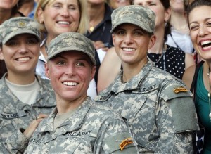 FILE - In this Aug. 21, 2015, file photo, Army 1st Lt. Shaye Haver, center, and Capt. Kristen Griest, right, pose for photos with other female West Point alumni after an Army Ranger school graduation ceremony at Fort Benning, Ga. Haver and Griest became the first female graduates of the Army's rigorous Ranger School. The decision by the Pentagon to allow women to serve in all combat jobs has put new focus on an often-forgotten U.S. institution: the Selective Service. While America has not had a military draft since 1973, all men must register with the Selective Service within 30 days of turning 18. U.S. leaders repeatedly insist that the all-volunteer force is working and the nation is not returning to the draft. But there are increasing rumblings about whether women should now be required to register if they can indeed serve in all areas of the military. (AP Photo/John Bazemore, File)