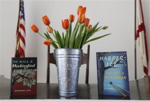 Harper Lee's two books, "To Kill a Mockingbird," and "Go Set A Watchman" are displayed with a bouquet of tulips in the Monroe County Heritage Museum old courthouse Friday, Feb. 19, 2016, in Monroeville, Ala. Lee, the elusive author, died Friday according to her publisher Harper Collins. She was 89. (AP Photo/Brynn Anderson)