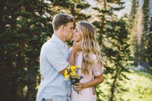 A couple kisses while posing for their engagement photos. Ashley has a variety of clients and is willing to shoot almost anything; that's one of the reasons she's been so successful in her business without a college degree (Ashley Photography).