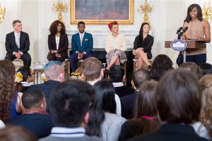 First lady Michelle Obama, accompanied by, from left, GRAMMY Museum Executive Director Bob Santelli, and performers Yolanda Adams, Leon Bridges, Andra Day, and Demi Lovato, speaks in the State Dinning Room of the White House in Washington, Wednesday, Feb. 24, 2016, during an interactive student workshop on the musical legacy of Ray Charles, where students from 10 schools and community organizations from across the country participate as part of the "In Performance at the White House" series. (AP Photo/Andrew Harnik)