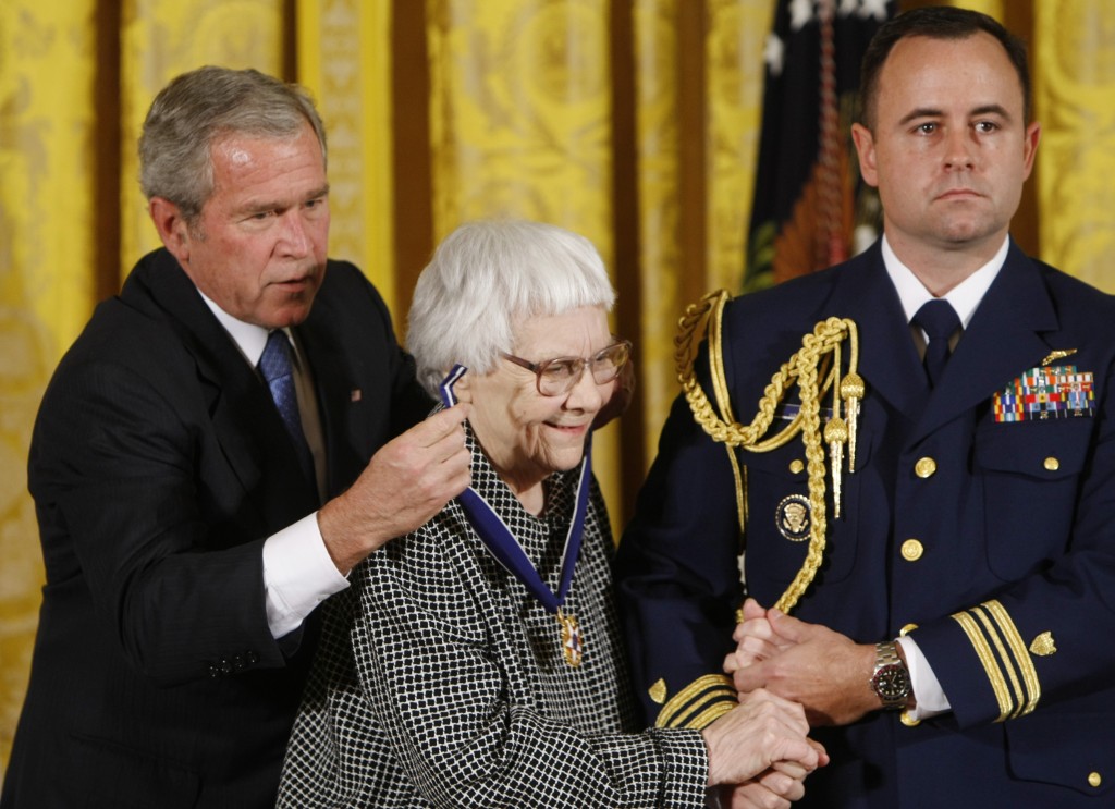 FILE - In this Nov. 5, 2007 file photo, President Bush, left, presents the Presidential Medal of Freedom to author Harper Lee, center, during a ceremony in the East Room of the White House in Washington. Lee, the elusive author of best-seller "To Kill a Mockingbird," died Friday, Feb. 19, 2016, according to her publisher, Harper Collins. She was 89. (AP Photo/Gerald Herbert, File)