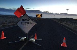 A closed Sod House Lane, about 4 miles outside of the Malheur National Wildlife Refuge in eastern Oregon, displays an electronic sign warning of arrest, Thursday morning, Feb. 11, 2016, near Burns, Ore. The last four armed occupiers of the national wildlife refuge in eastern Oregon said they would turn themselves in Thursday morning, after law officers surrounded them in a tense standoff. (AP Photo/Rebecca Boone)